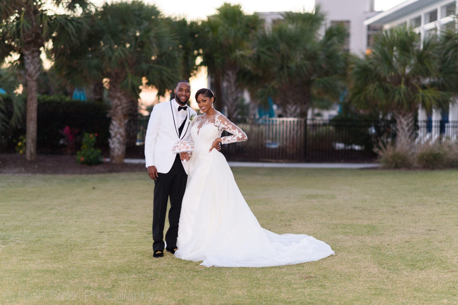 Bride and groom in front of the palm trees  - Doubletree Resort by Hilton Myrtle Beach