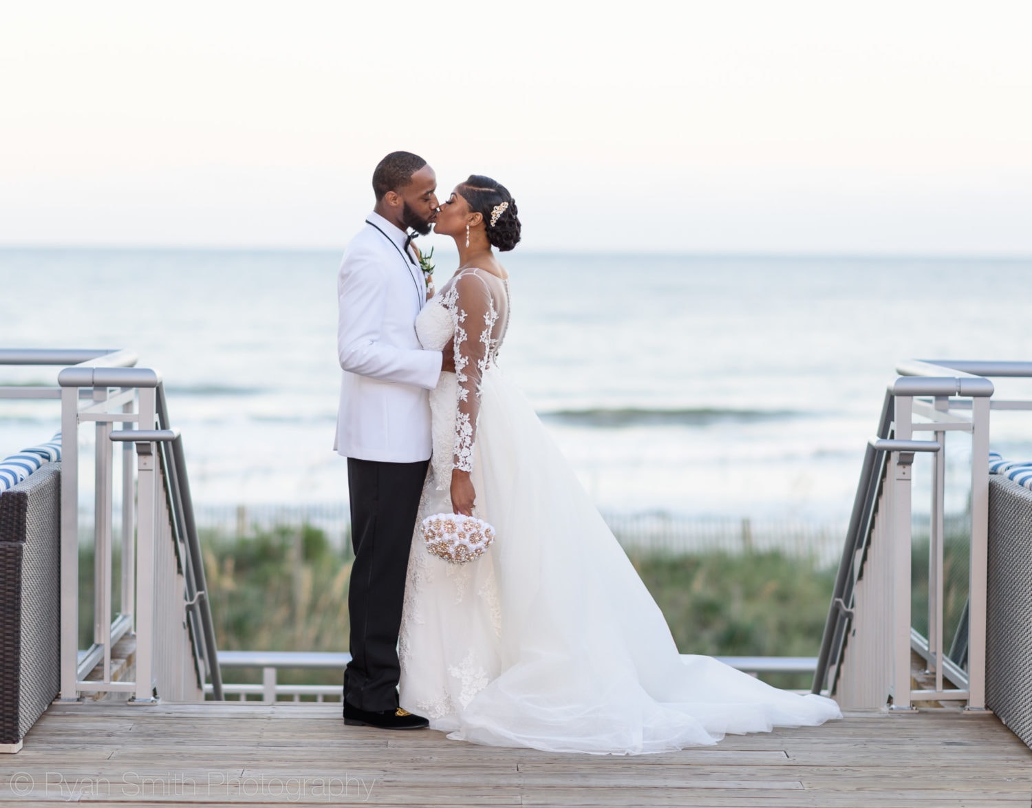 Bride and groom kissing on the balcony - Doubletree Resort by Hilton Myrtle Beach