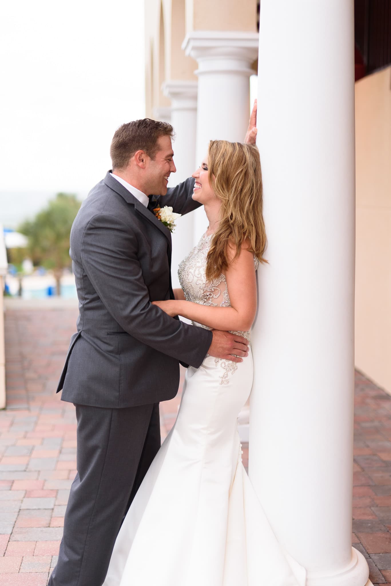 Bride and groom leaning against the columns - Grande Dunes Ocean Club - Myrtle Beach