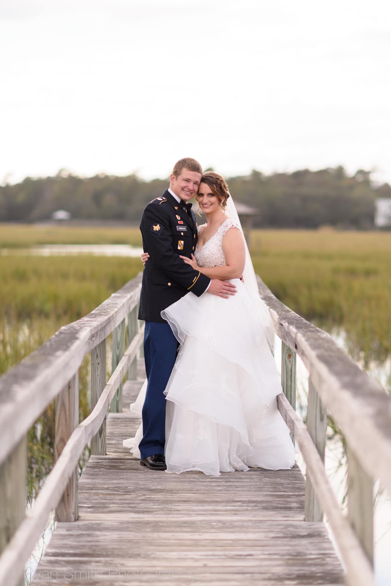 Bride and groom smiling on the marsh boardwalk - Pawleys Island Chapel
