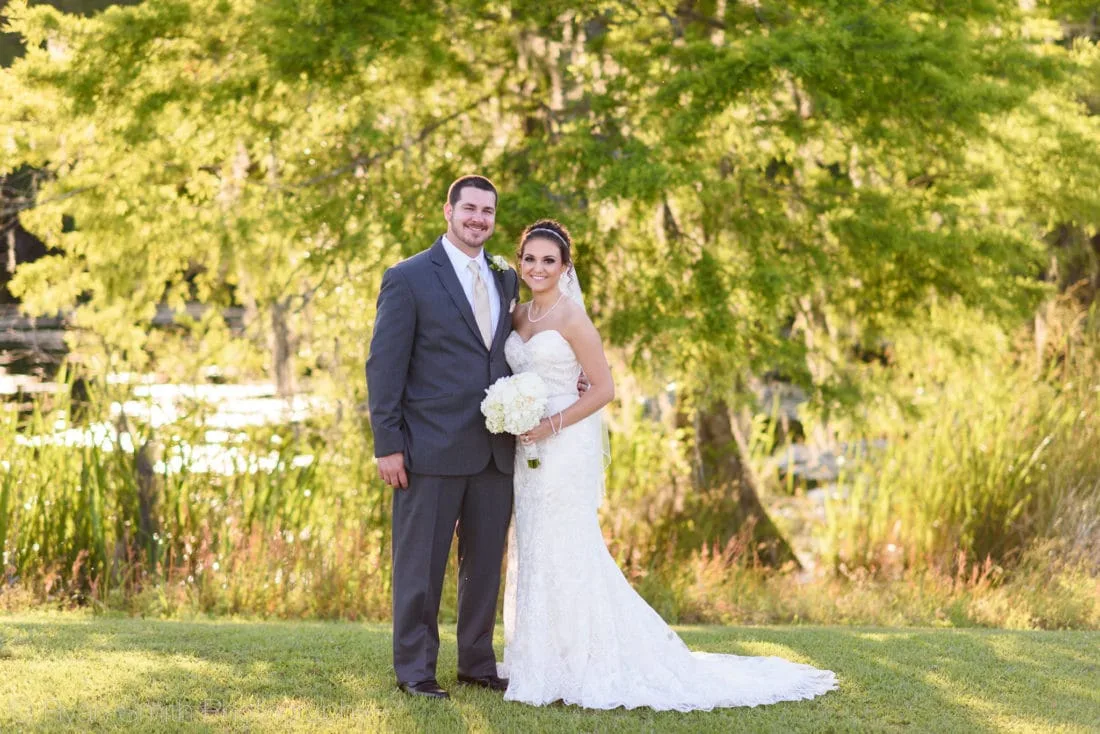 Bride and groom with sunset reflecting in the marsh - Upper Mill Plantation