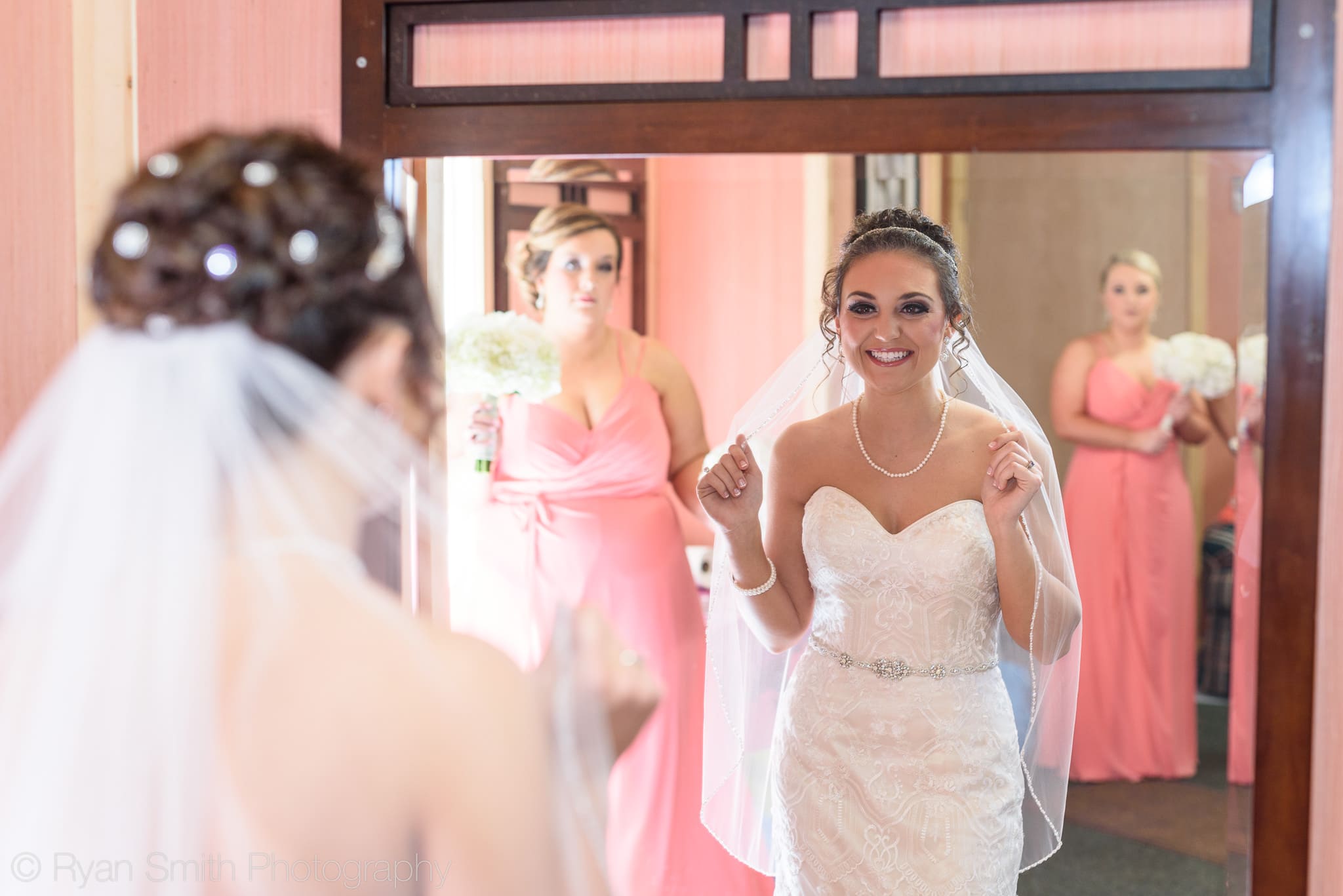Bride checking out her veil in a mirror - Upper Mill Plantation