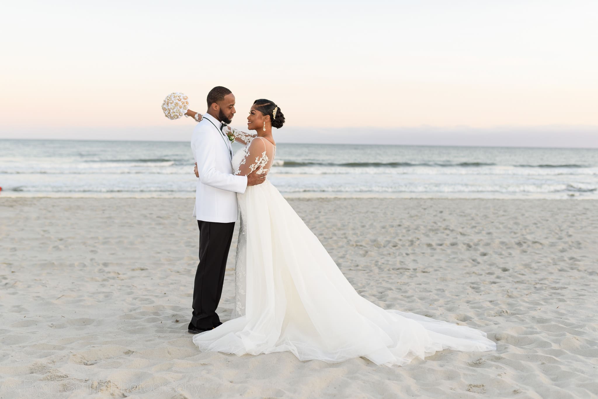 Bride holding flowers around grooms neck - Doubletree Resort by Hilton Myrtle Beach