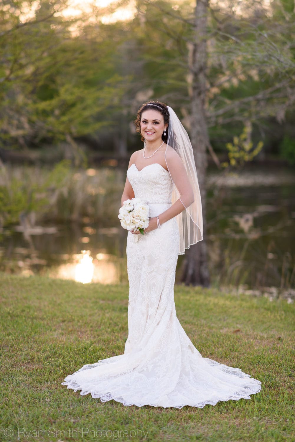 Bride holding her flowers in front of the sunset - Upper Mill Plantation