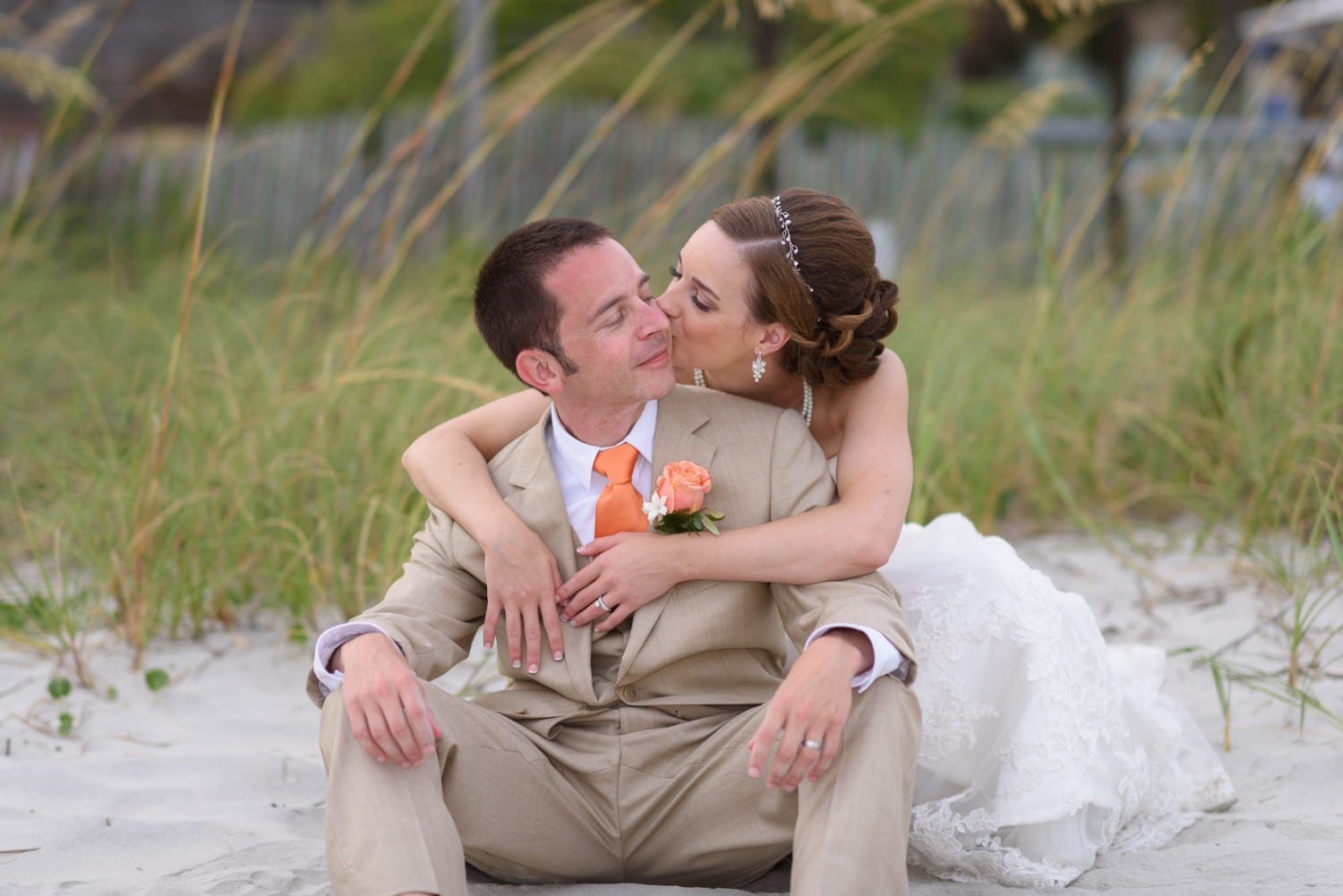 Bride kissing groom on cheek  - Hilton at Kingston Plantation
