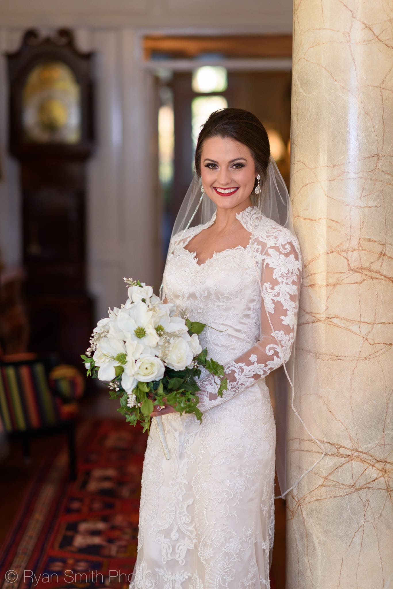 Bride leaning against columns entryway of Rosewood Manor - Rosewood Manor, Marion