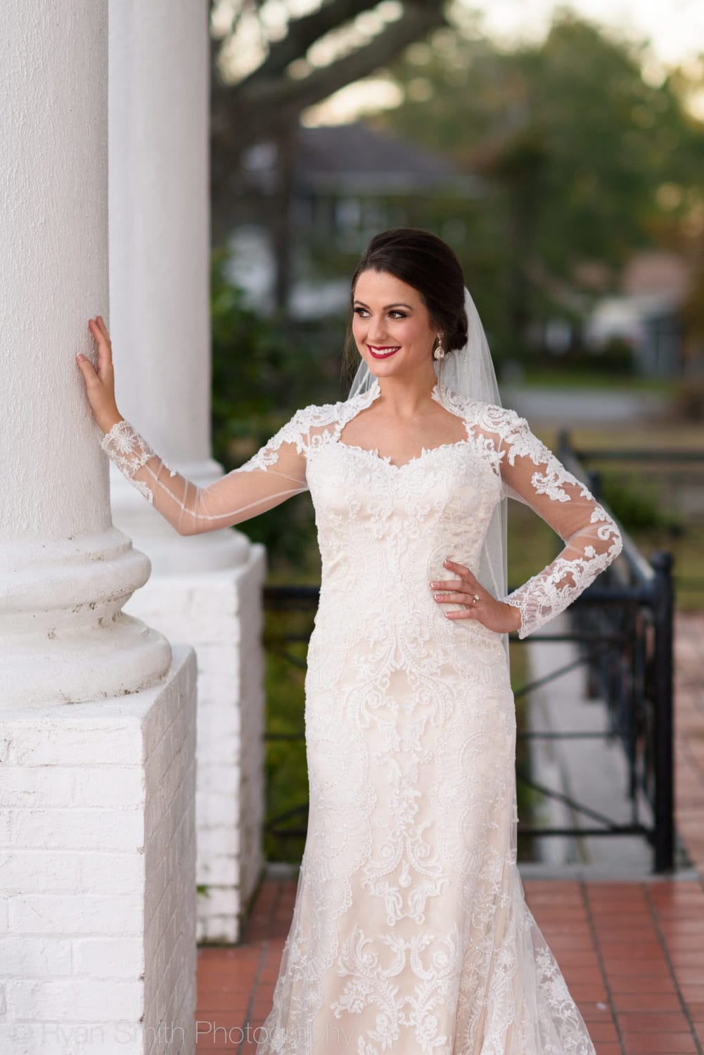 Bride leaning against front columns - Rosewood Manor - Marion - Rosewood Manor, Marion