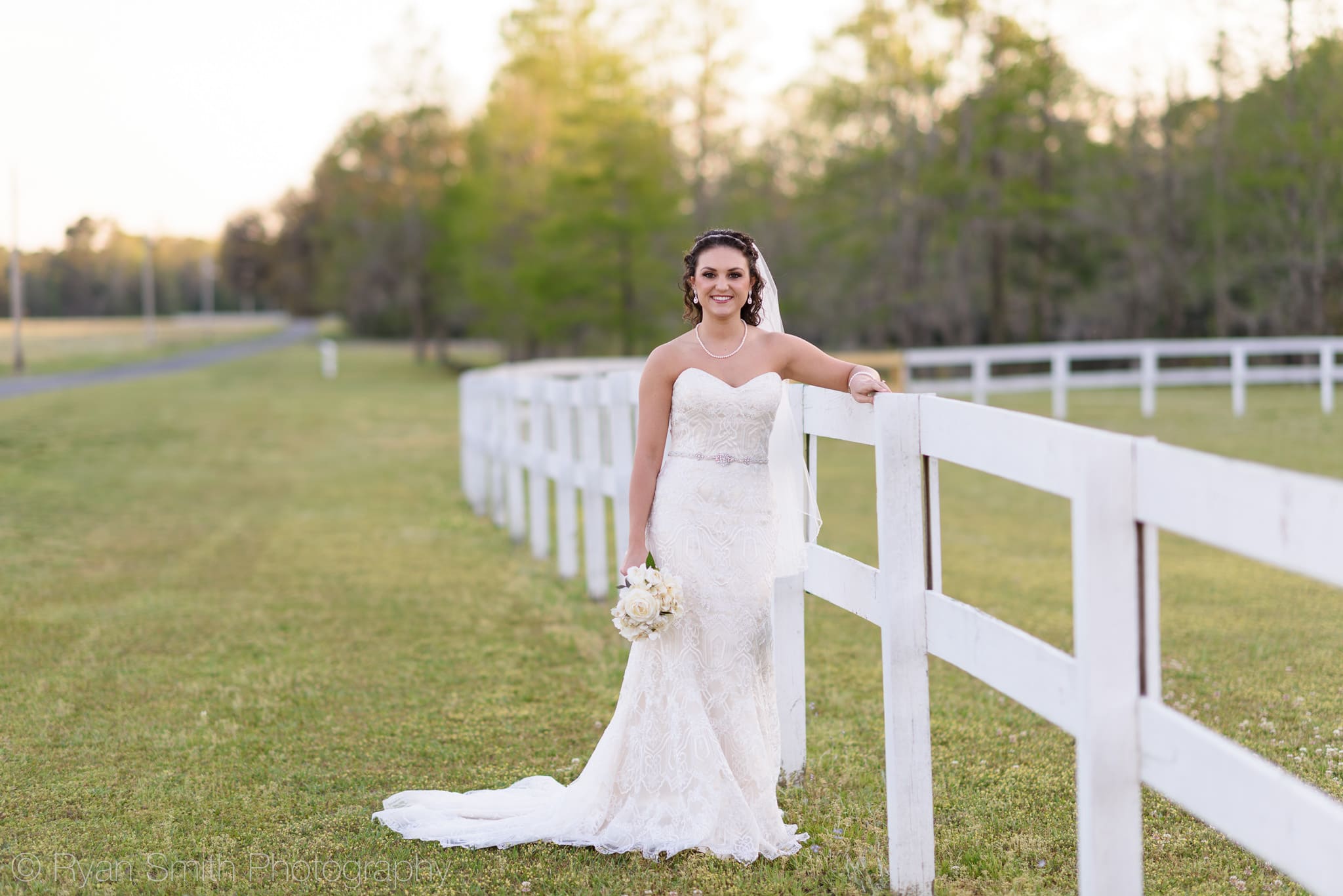 Bride leaning against the fence - Upper Mill Plantation