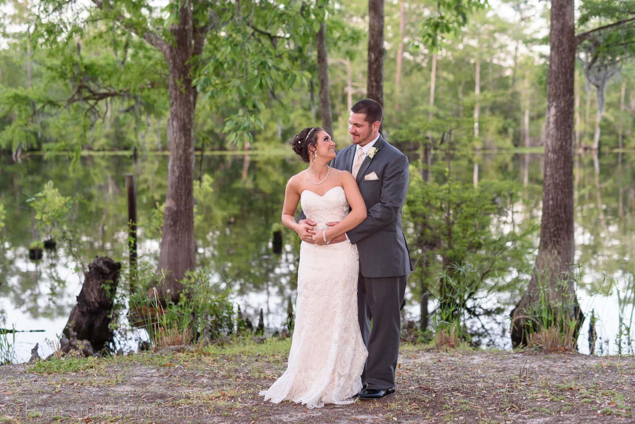 Bride looking back at groom beside the Waccamaw River - Upper Mill Plantation