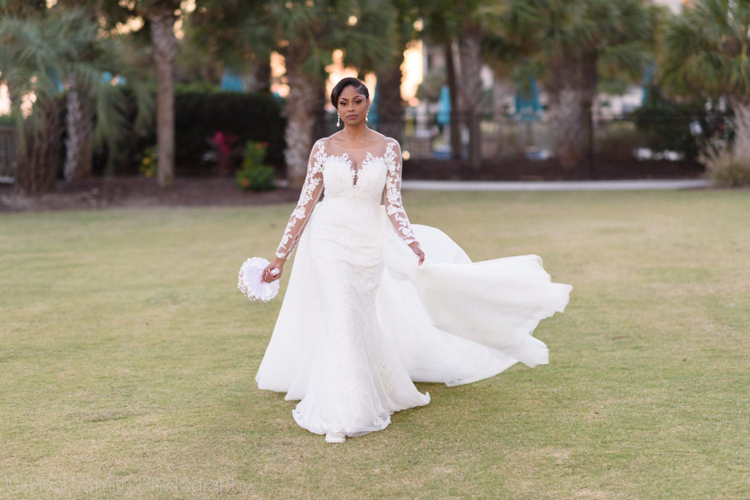 Bride portraits walking towards the camera backlit by sunset - Doubletree Resort by Hilton Myrtle Beach