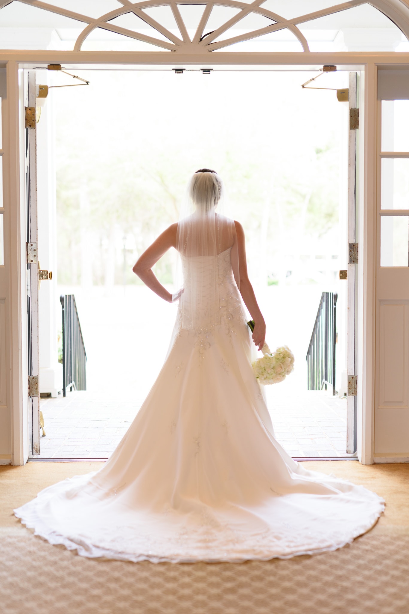 Bride posing in the sunlight from the doorway - Pawleys Plantation