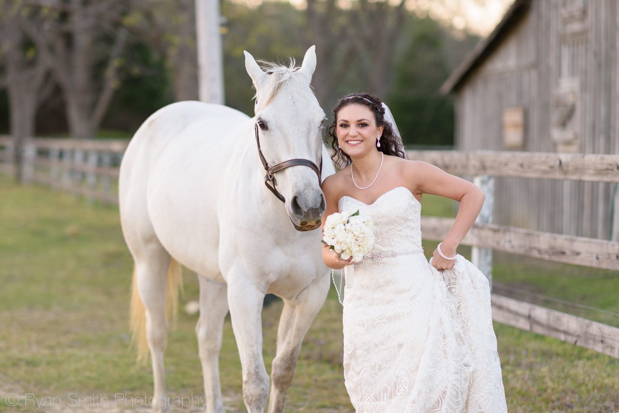Bride posing with her cheek beside the horse - Upper Mill Plantation