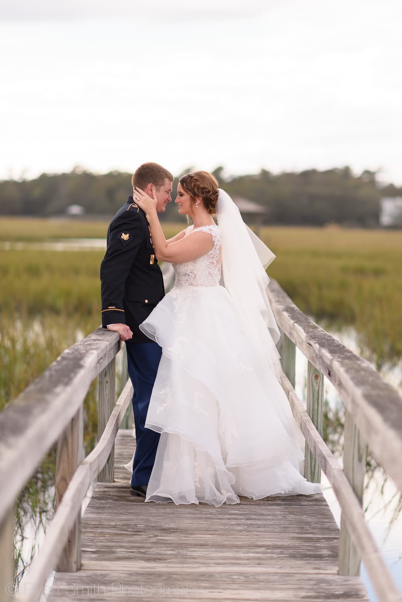 Bride pulling husband in for a kiss - Pawleys Island Chapel