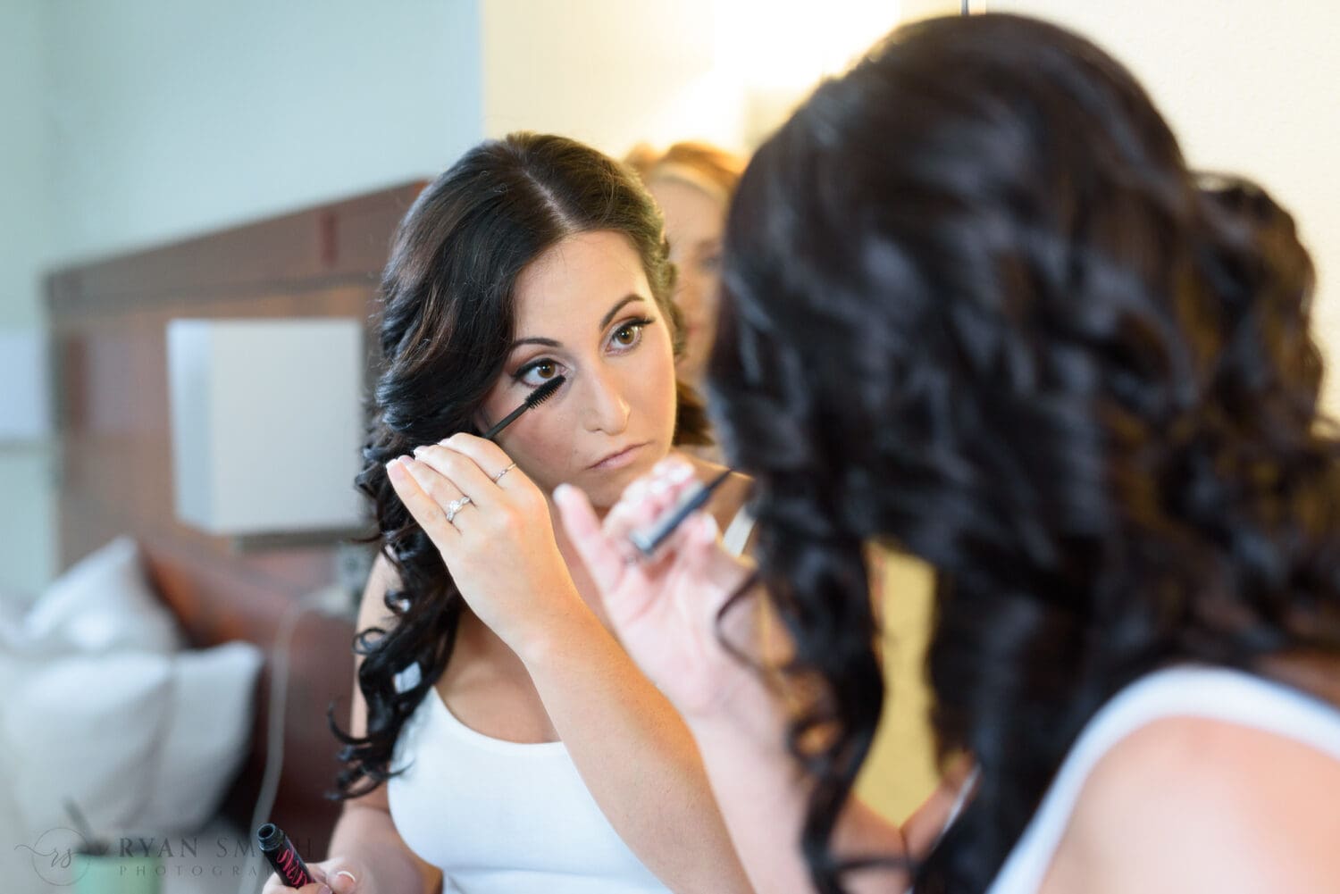 Bride putting on makeup in the mirror - La Belle Amie Vineyard