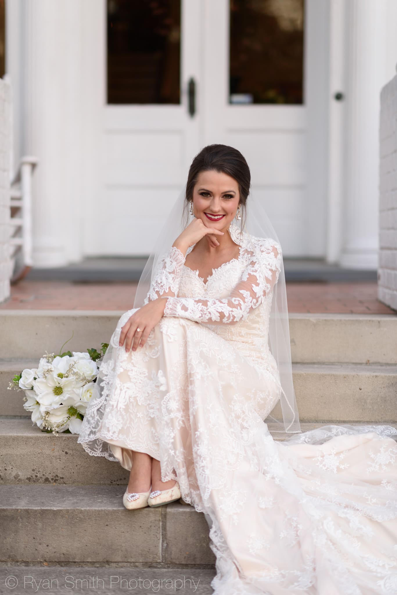 Bride sitting on steps leaning on her hand - Rosewood Manor, Marion