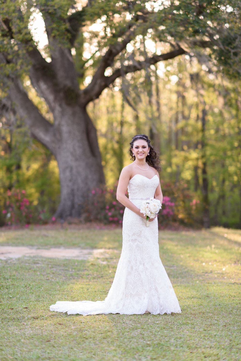 Bride standing in front of a tree - Upper Mill Plantation