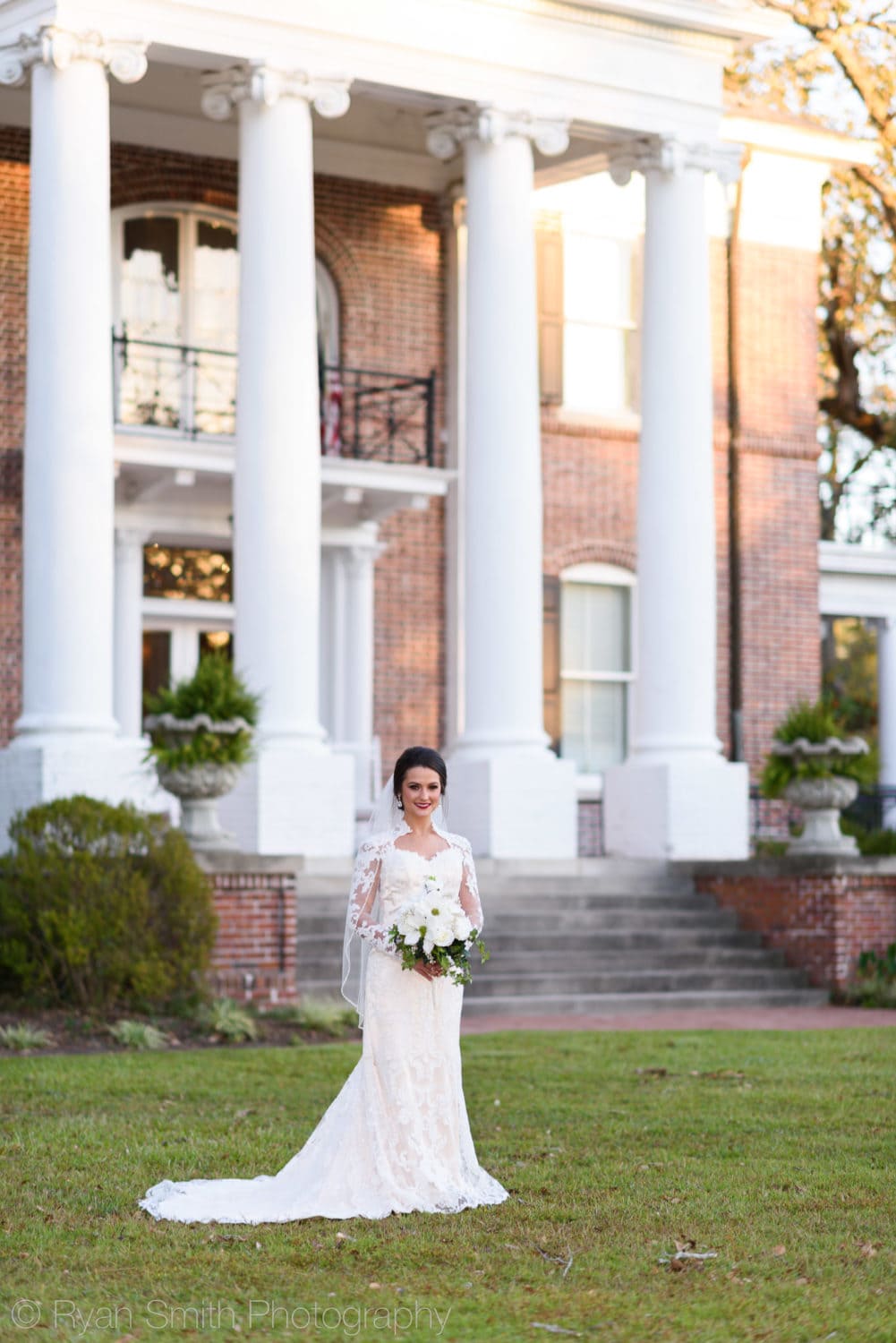 Bride standing in front of entryway columns - Rosewood Manor - Marion - Rosewood Manor, Marion