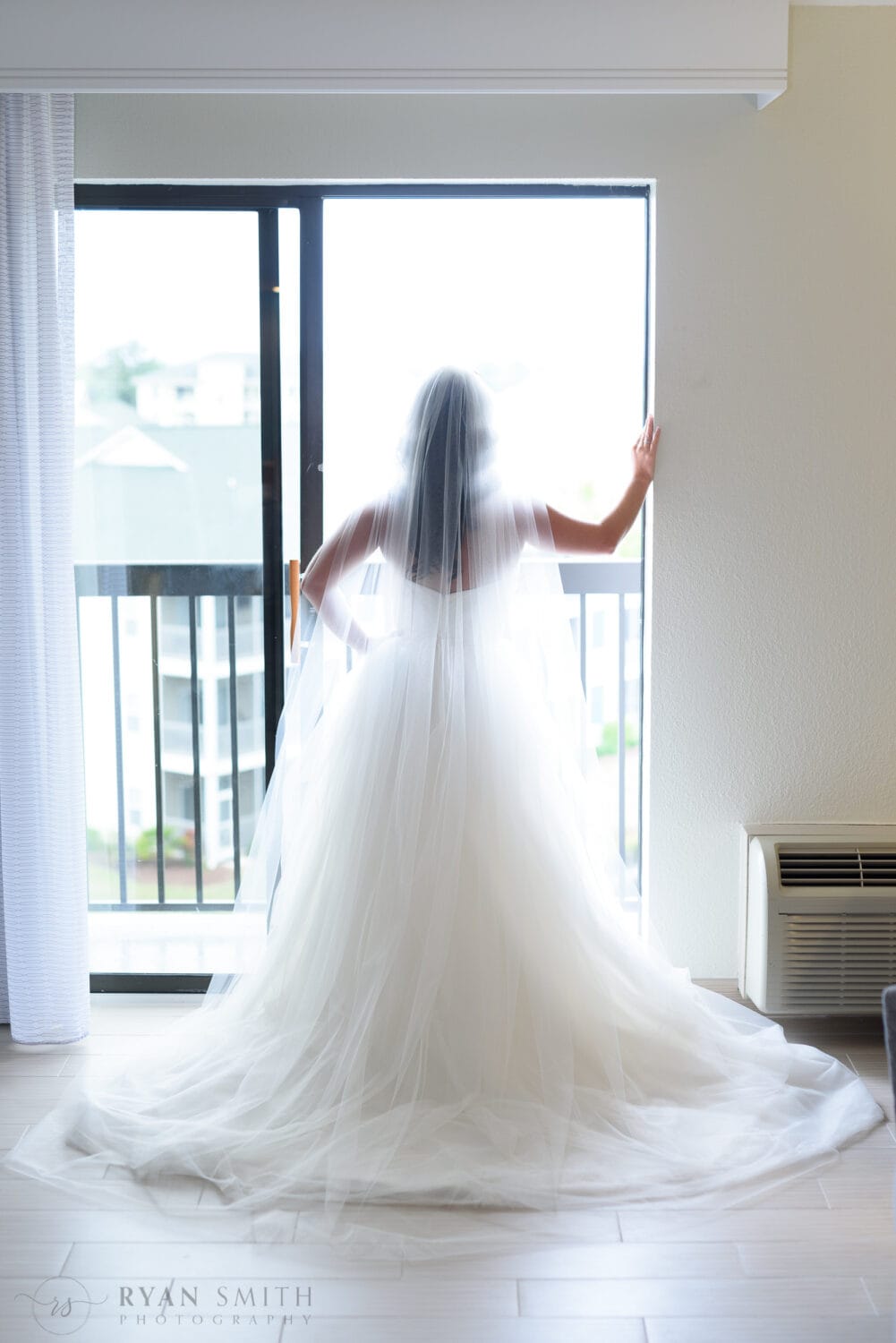 Bride standing in hotel doorway - La Belle Amie Vineyard