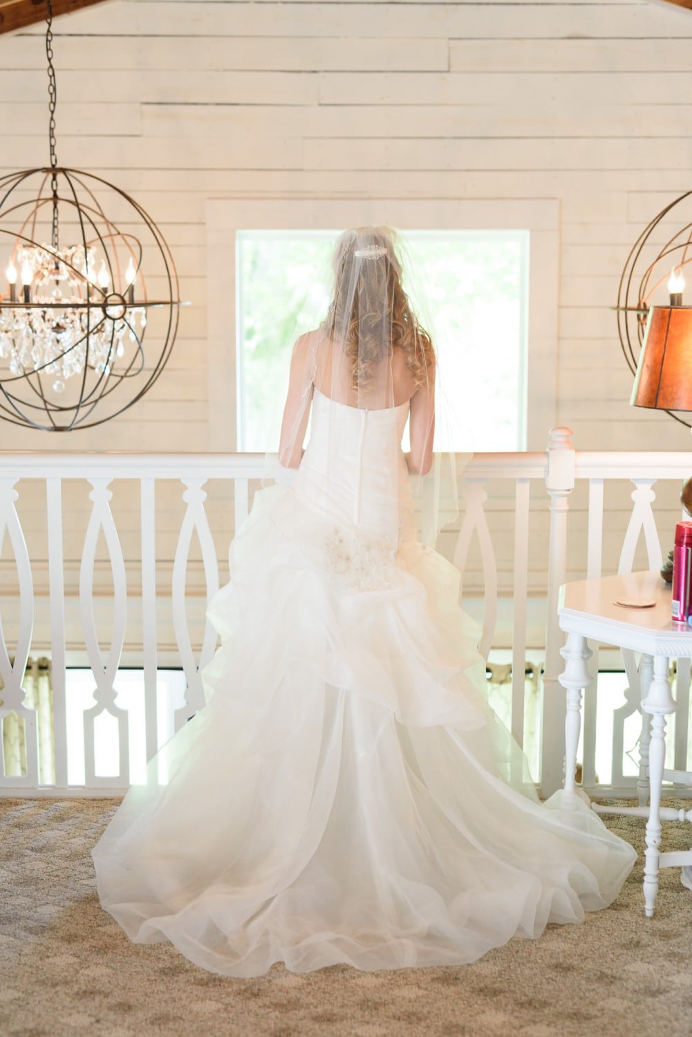 Bride standing on cottage balcony - Wildberry Farm