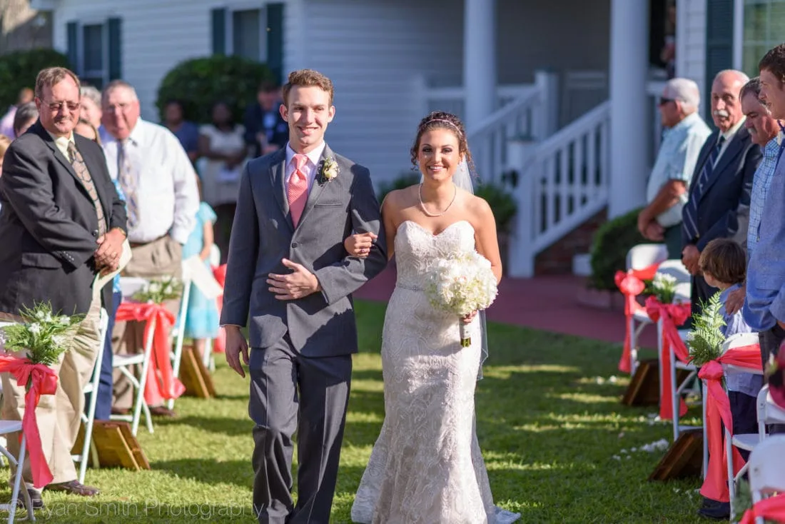 Bride walks down the aisle with her brother at Upper Mill Plantation