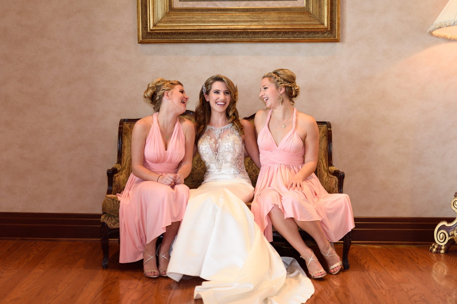 Bride with bridesmaids laughing on the couch - Grande Dunes Ocean Club - Myrtle Beach