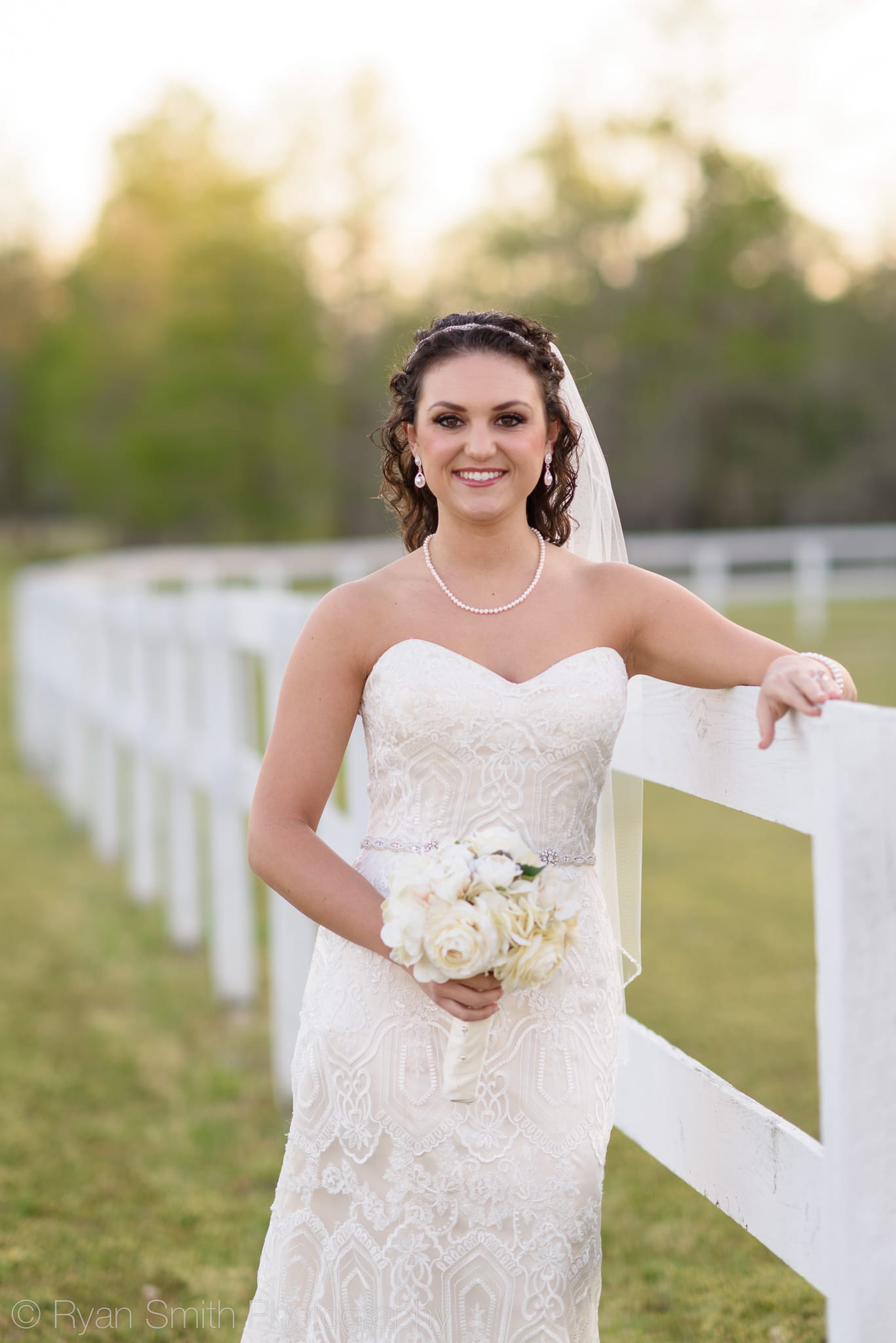 Bride with her arm on the white fence - Upper Mill Plantation
