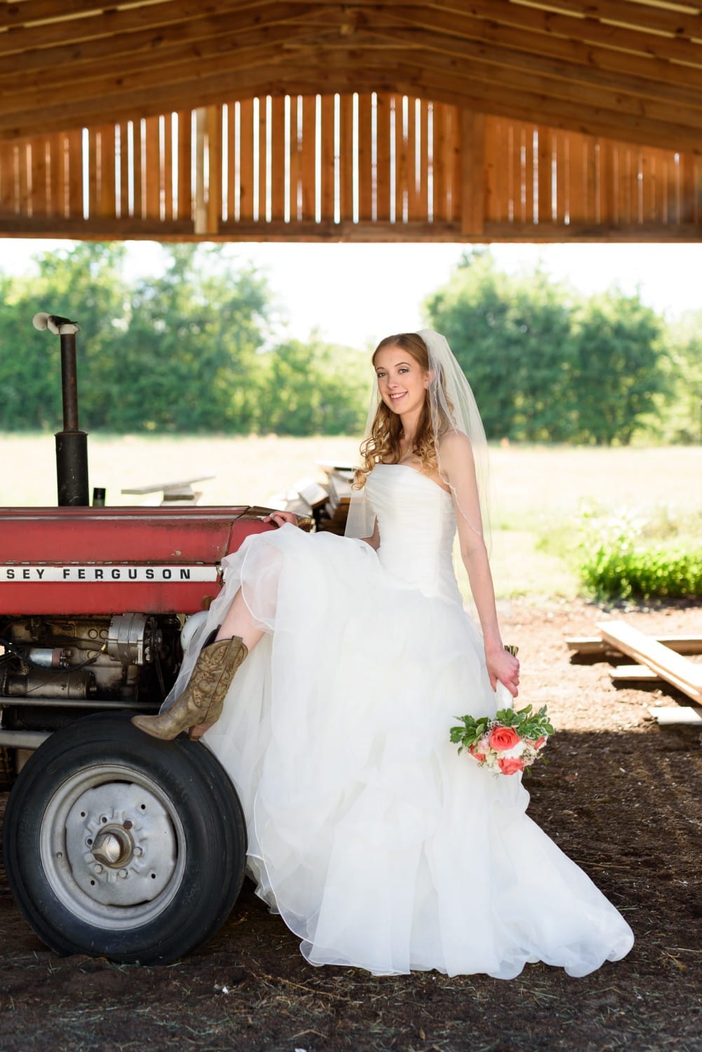 Bride with her cowboy boot on tractor - Wildberry Farm