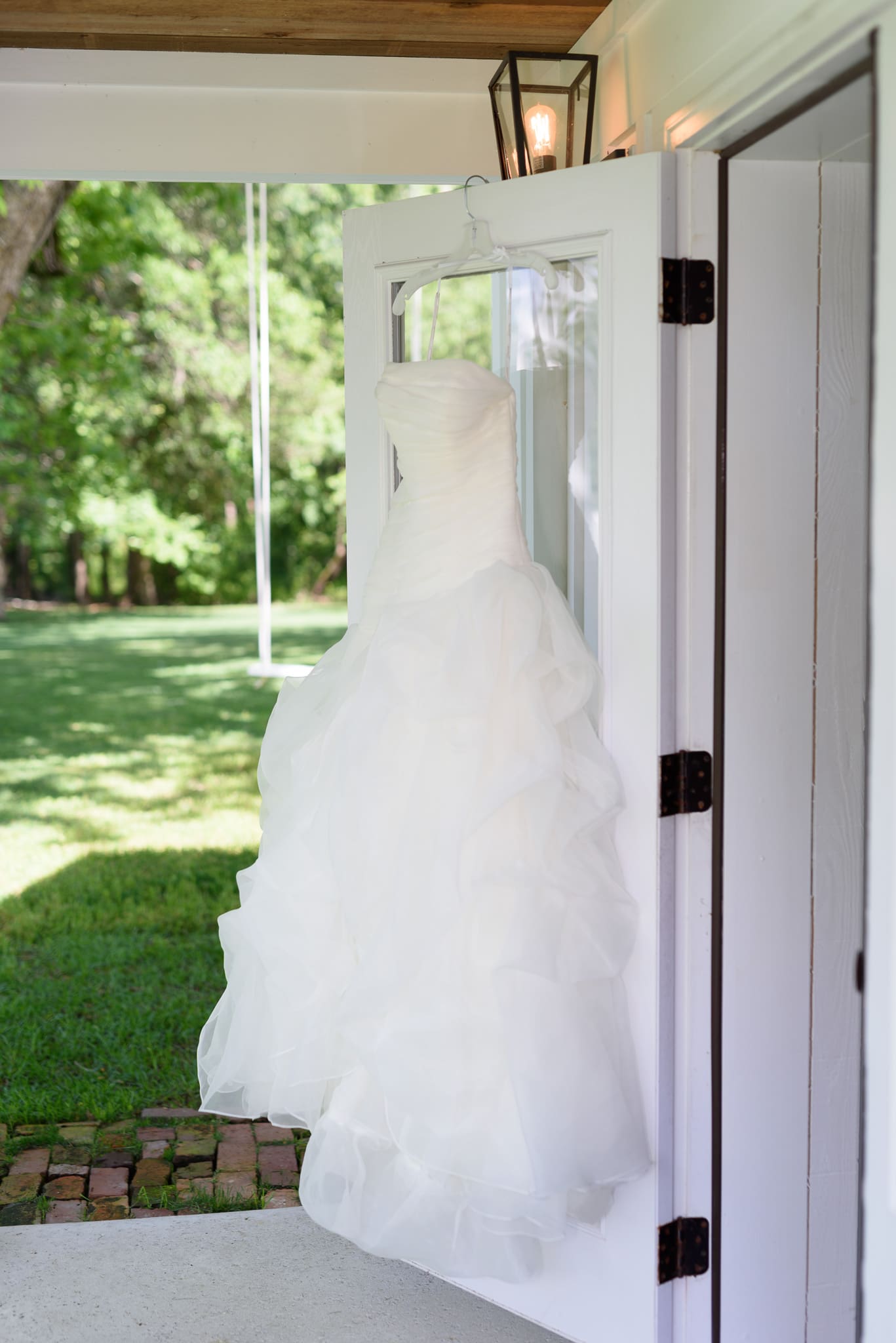 Bride's dress hanging from door - Wildberry Farm