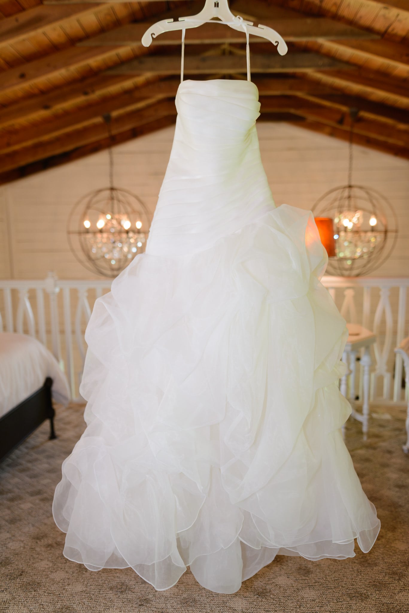 Bride's dress hanging from rafters in cottage - Wildberry Farm