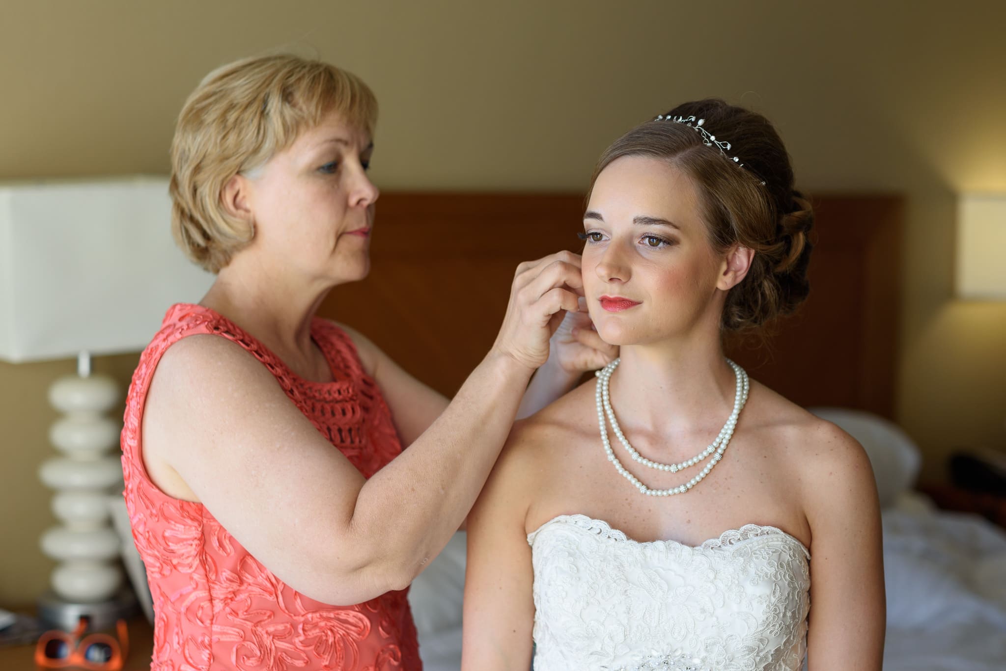 Bride's mom putting on bride's earings - Hilton at Kingston Plantation