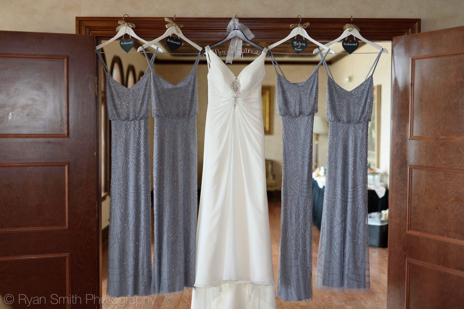 Bridesmaid dresses hanging in doorway - Grande Dunes Ocean Club