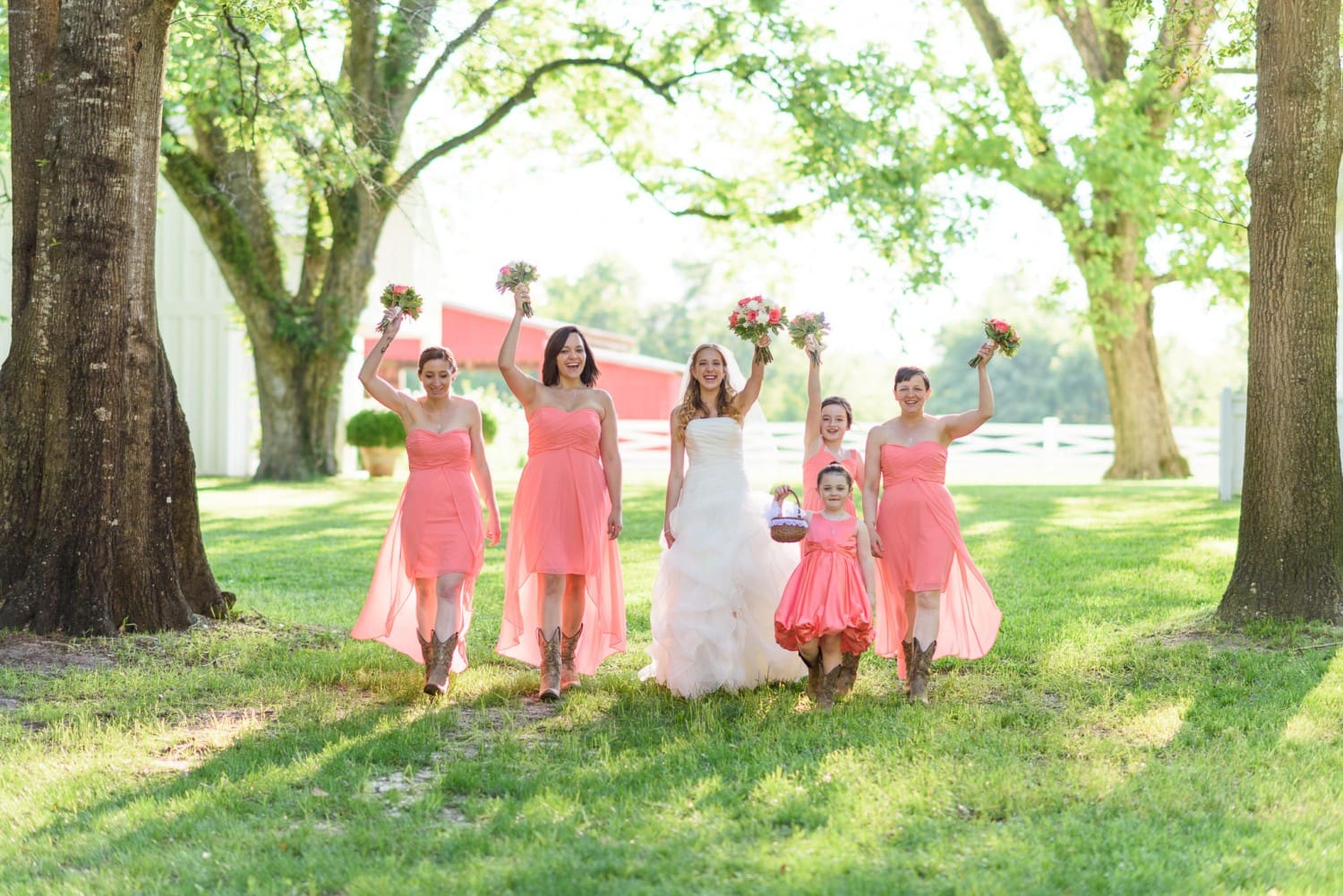 Bridesmaids holding flowers in the air - Wildberry Farm