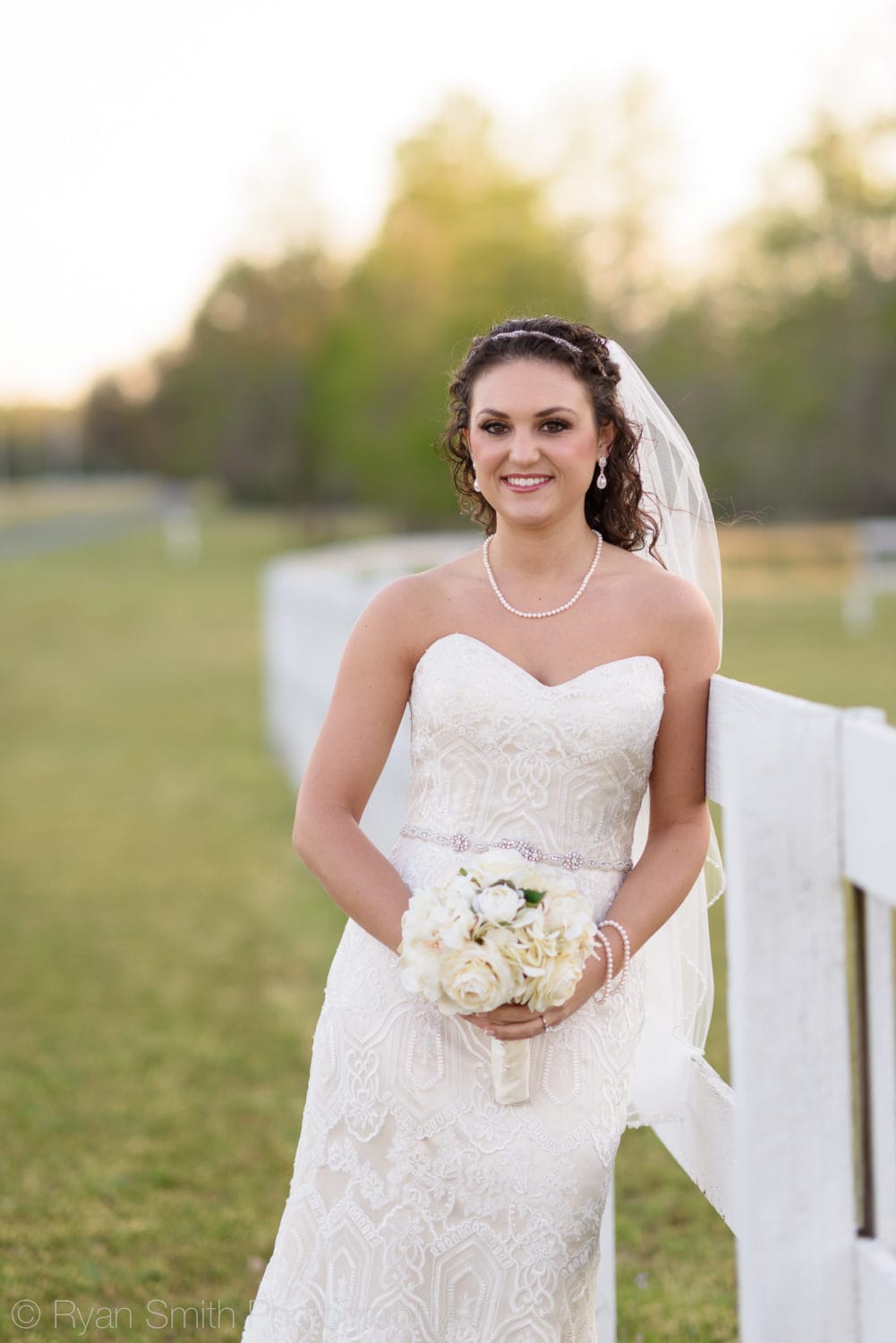 Close up bride leaning against fence  - Upper Mill Plantation