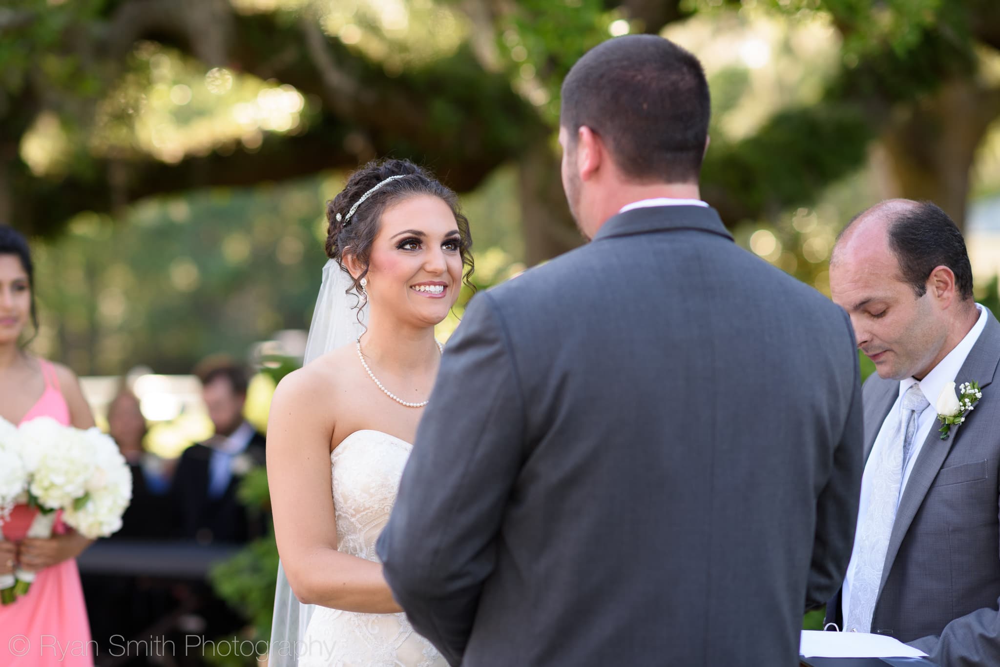 Closeup of bride smiling at groom during vows - Upper Mill Plantation