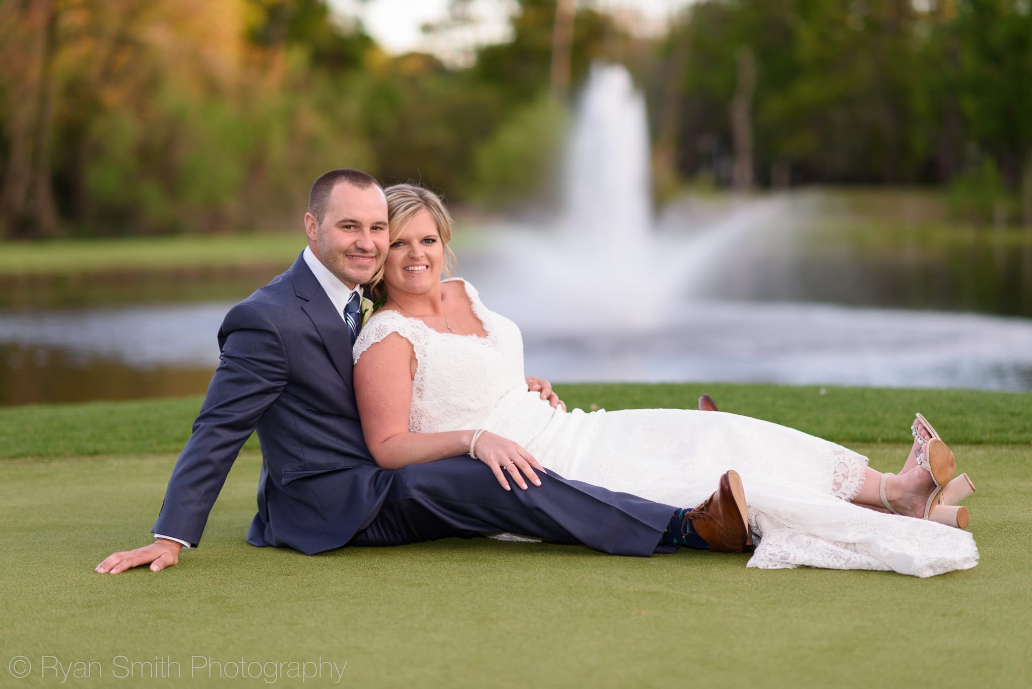 Couple sitting on the wet grass for a picture - Pawleys Plantation