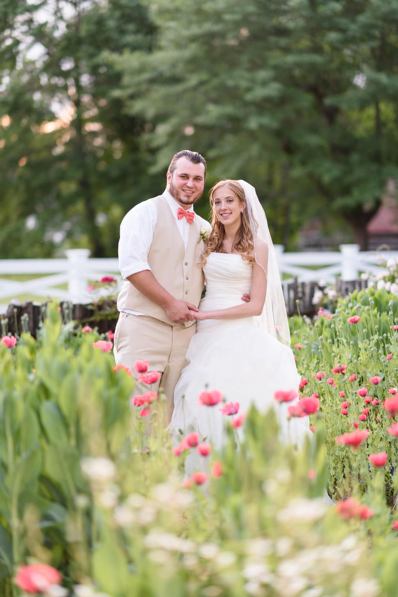 Couple smiling at camera surrounded by flowers - Wildberry Farm