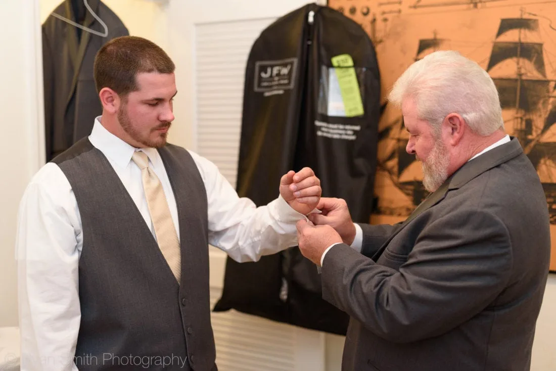Dad helping groom with cufflinks - Upper Mill Plantation