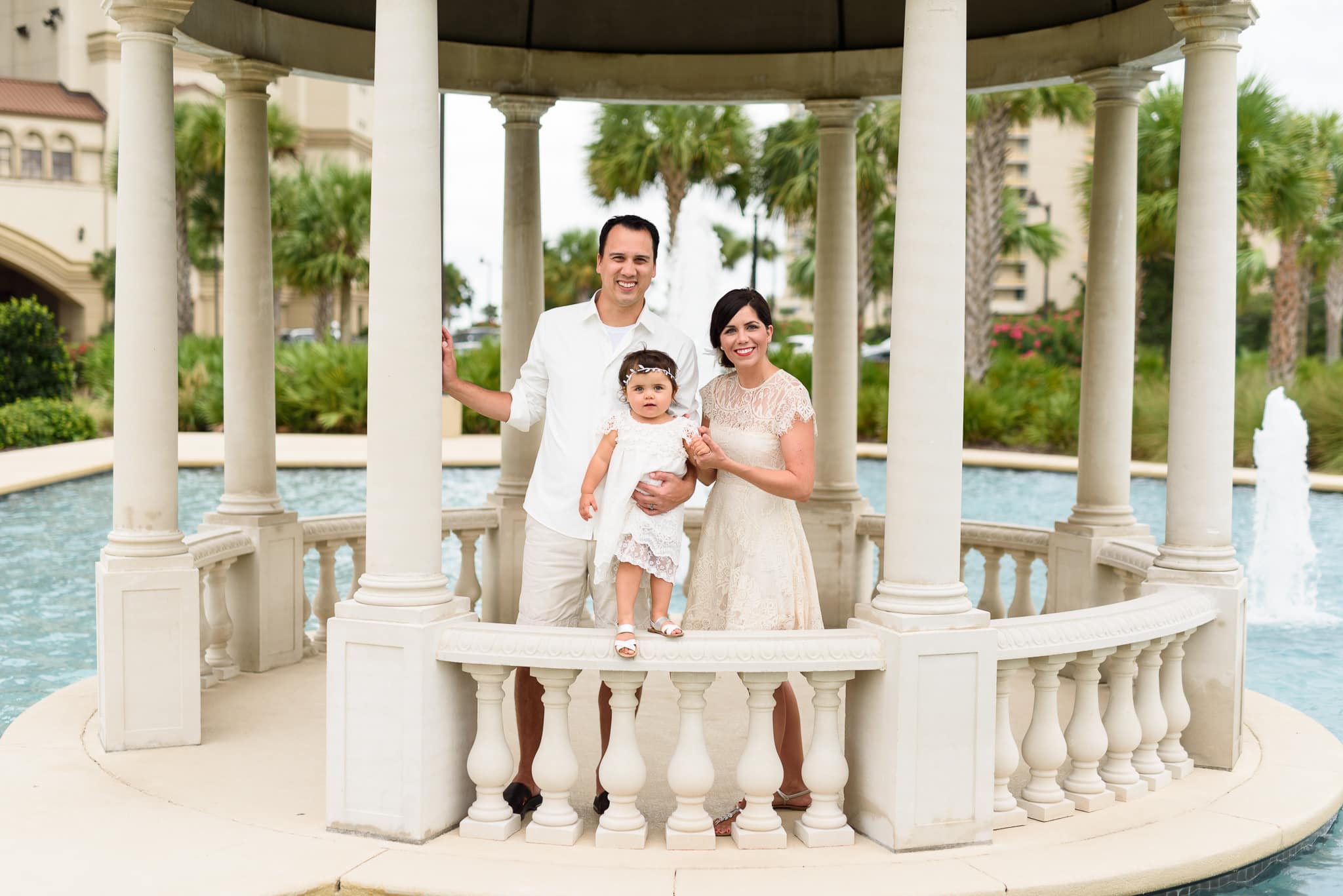 Family of three by the columns testing long caption testing long caption testing long caption - North Beach Plantation
