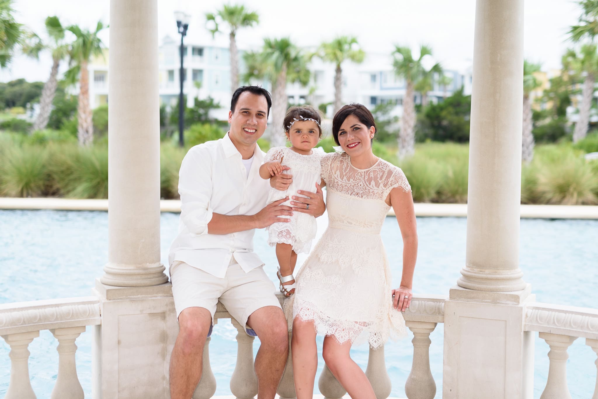 Family of three sitting by the fountains - North Beach Plantation