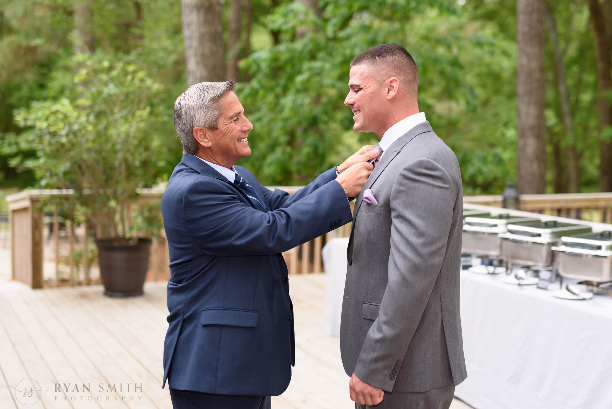 Father helping groom with his tie - La Belle Amie Vineyard
