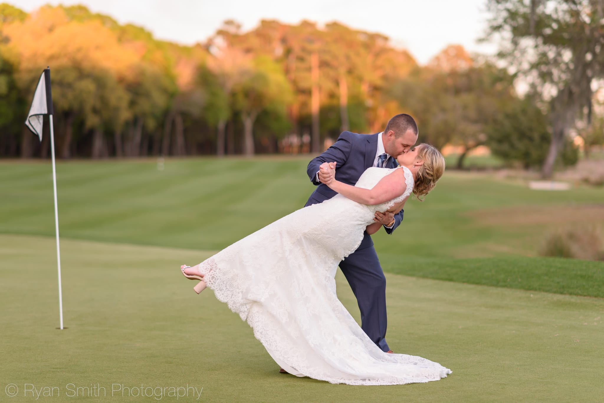 Groom dipping bride back for a kiss - Pawleys Plantation