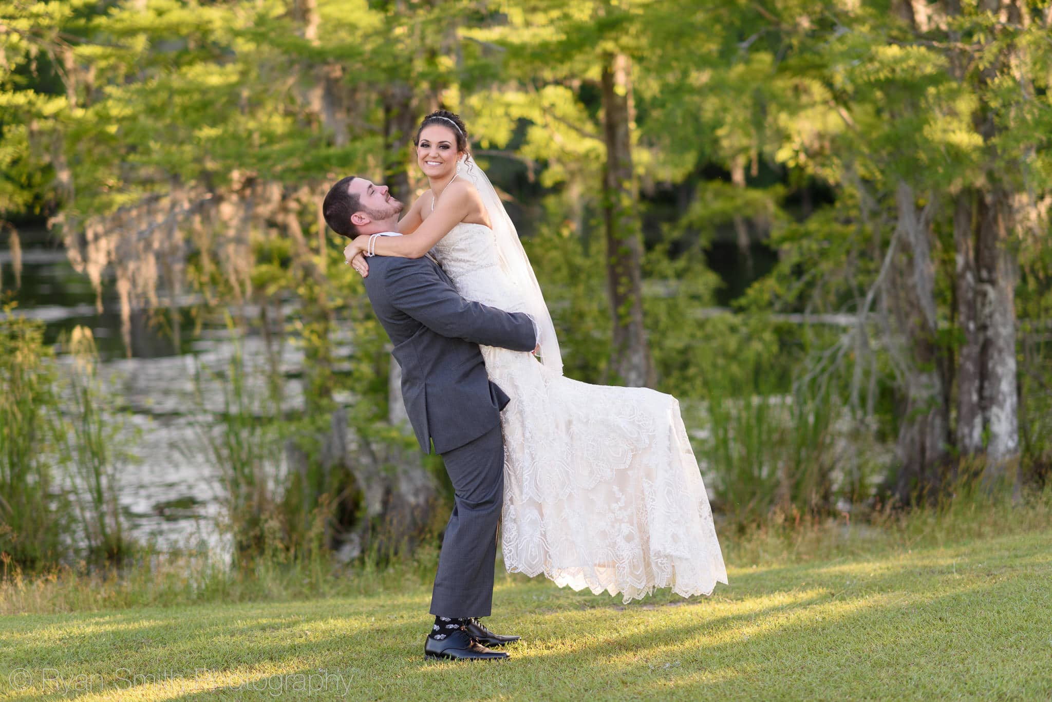 Groom lifting bride into the air - Upper Mill Plantation