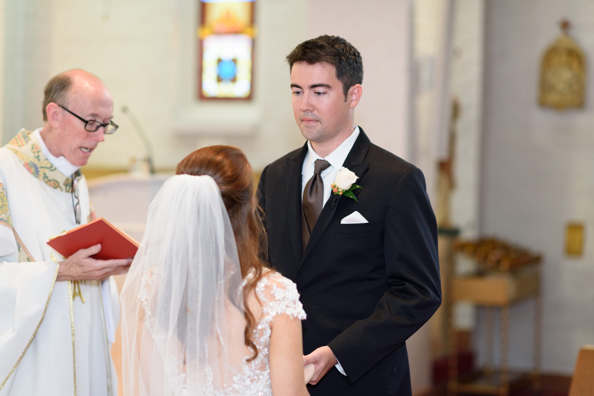 Groom looking at bride during vows - Historic Church downtown Georgetown