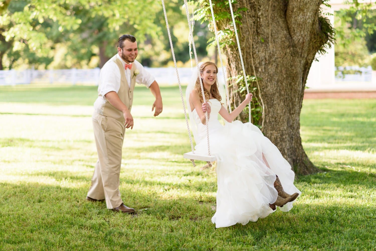 Groom pushing bride on swing - Wildberry Farm