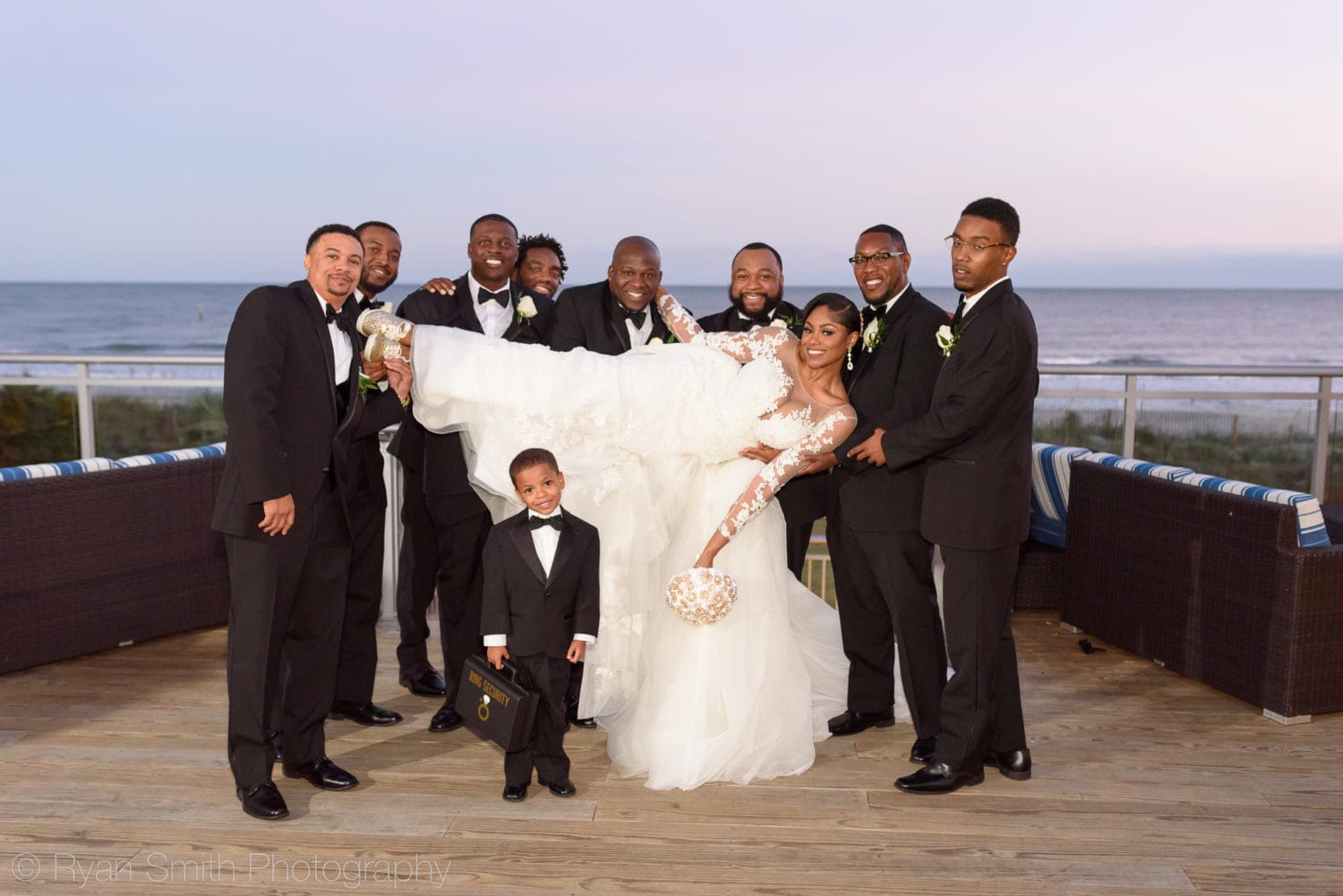 Groomsmen lifting up bride into the air - Doubletree Resort by Hilton Myrtle Beach