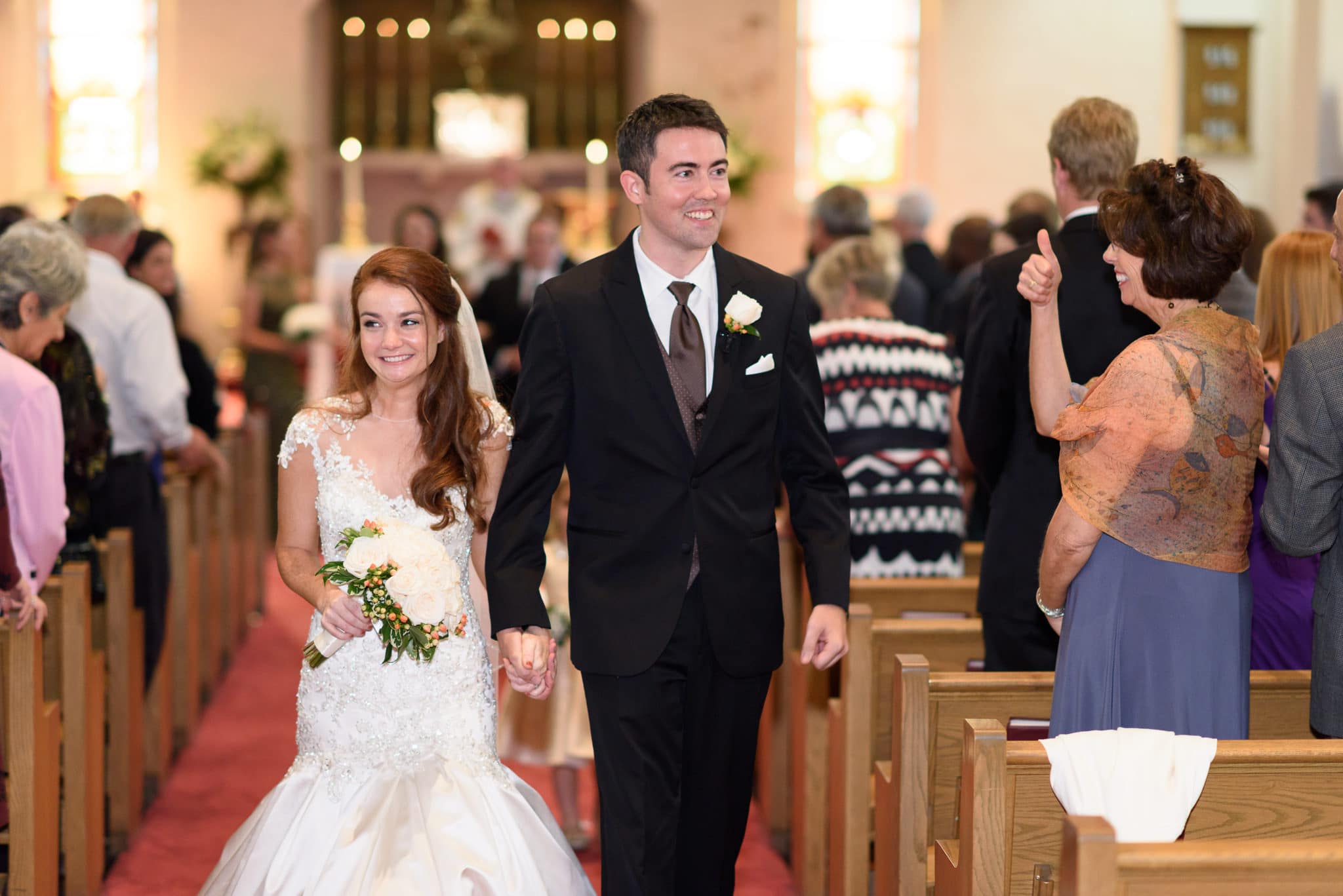 Happy bride and groom walking down isle after ceremony - Historic Church downtown Georgetown