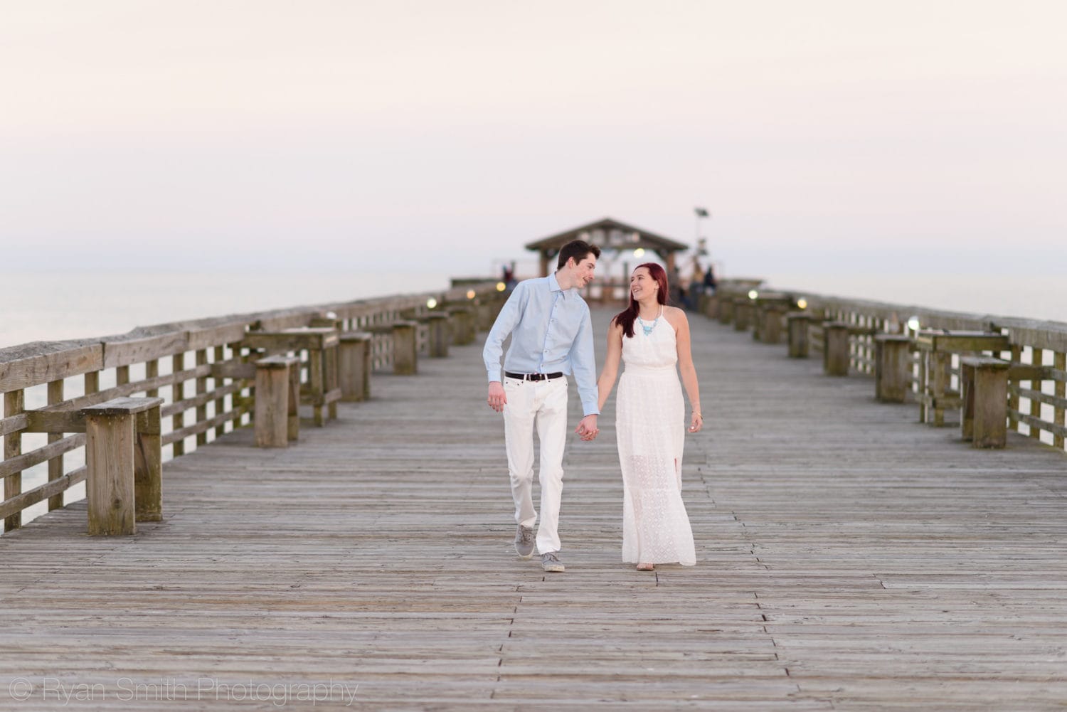 Holding hands walking down the pier - Myrtle Beach State Park