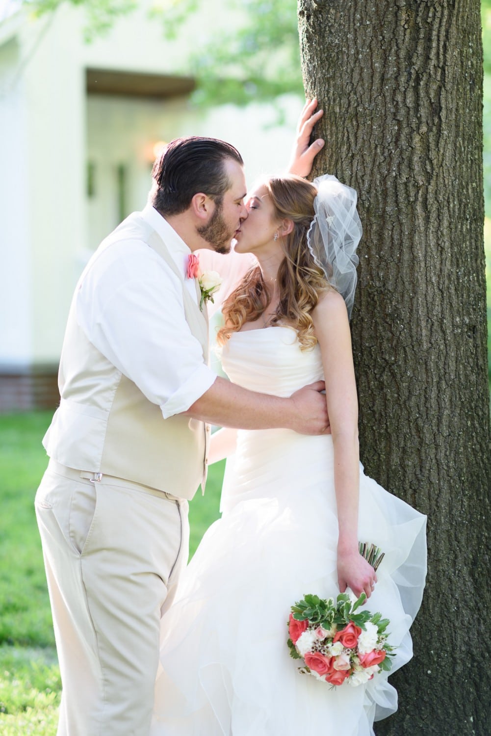 Just married couple kissing by a tree - Wildberry Farm