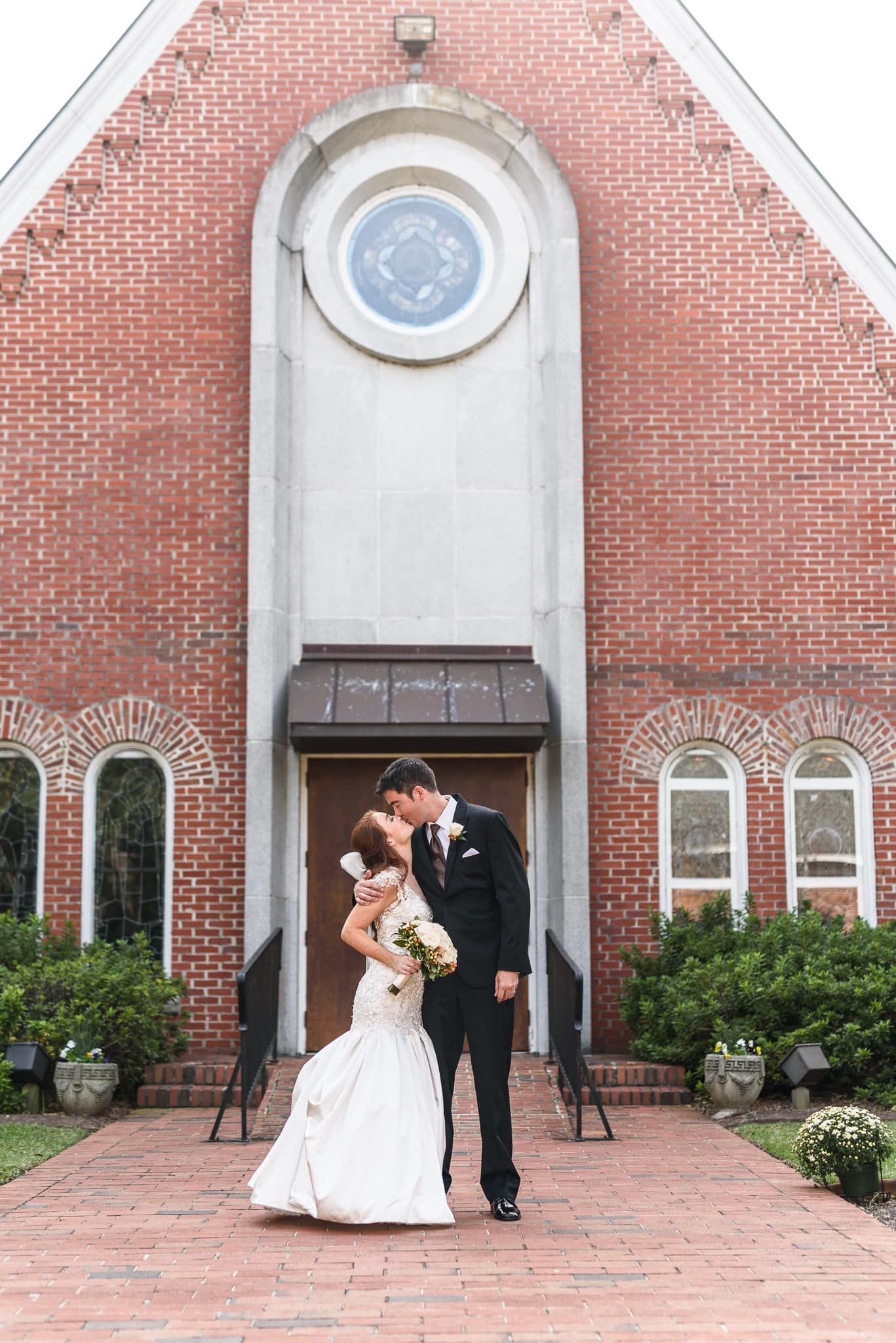 Kiss in front of the wedding location - Historic Church downtown Georgetown
