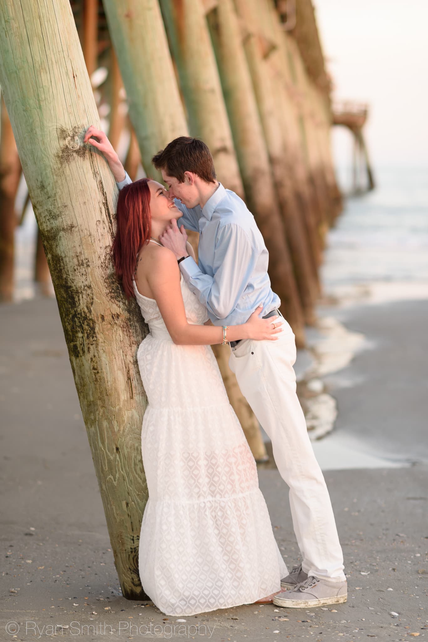 Leaning against the pier for a kiss - Myrtle Beach State Park